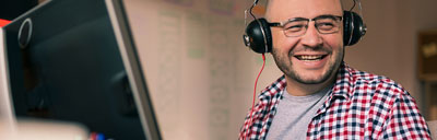 student with headphones working on computer